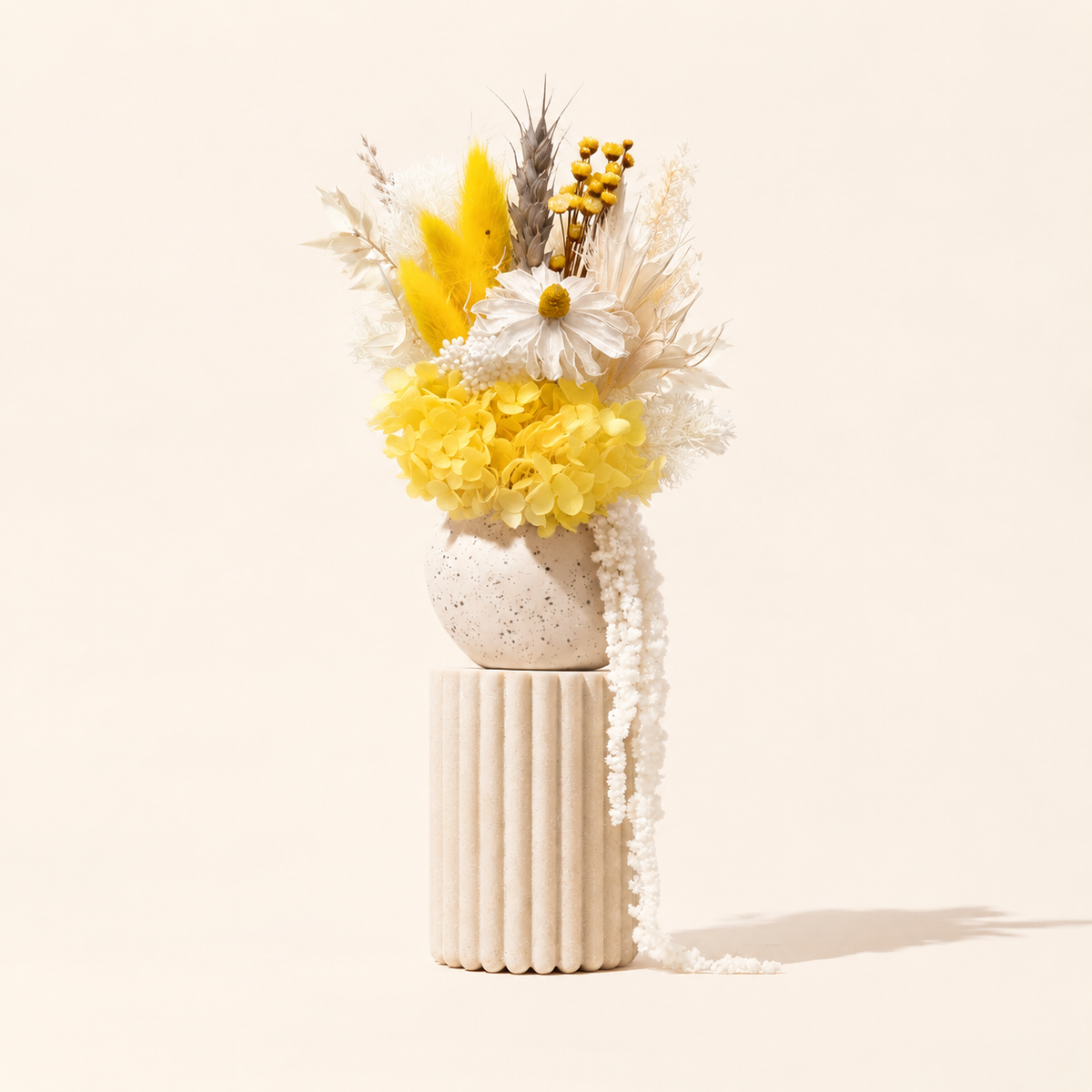 Indie yellow and white dried flower arrangement in handmade vase