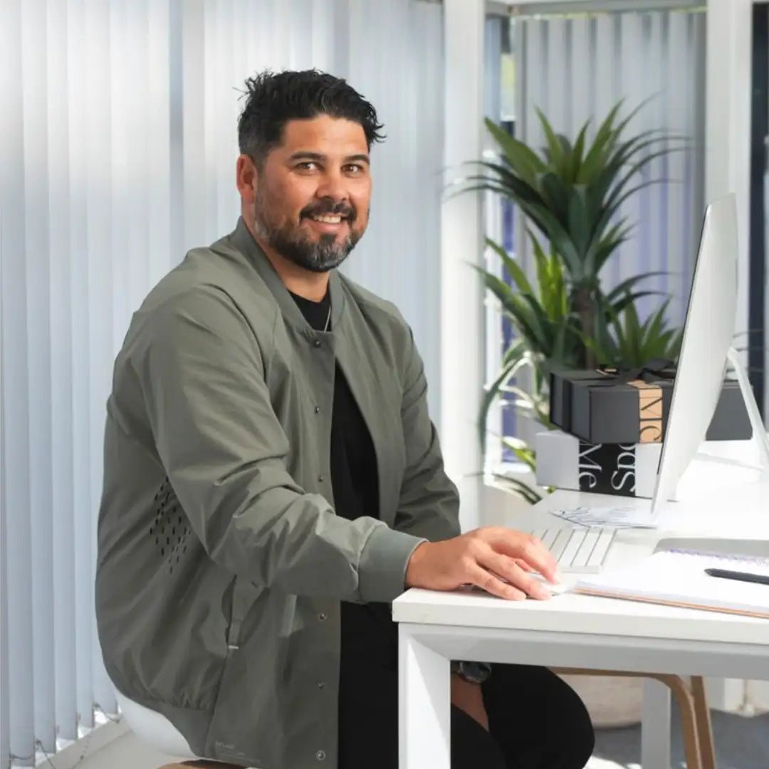 Man wearing olive green bomber jacket over black shirt