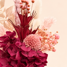 Pink dried flower arrangement with deep maroon florals
