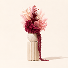 Ruby pink and deep maroon dried flower arrangement in handmade vase