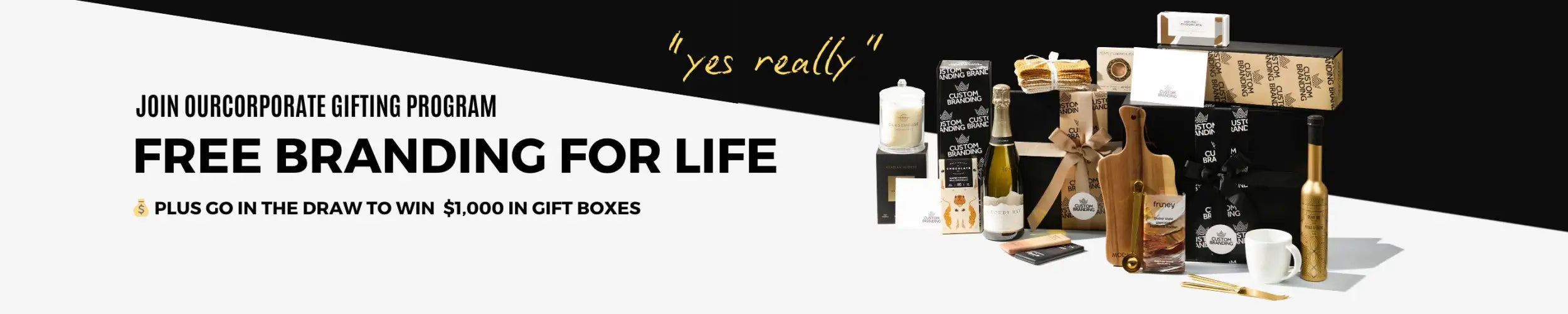 Black and gold gift boxes, wine bottles, candles, and a white mug arranged on a clean surface.