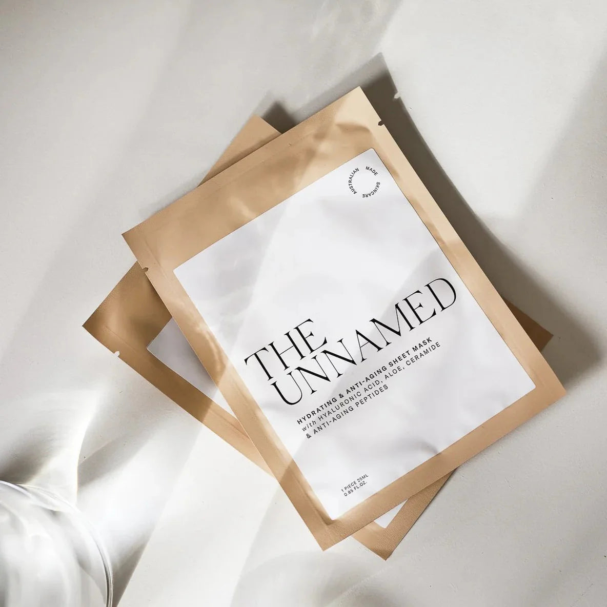 Sheet mask packaging with 'The Unnamed' branding on a white background