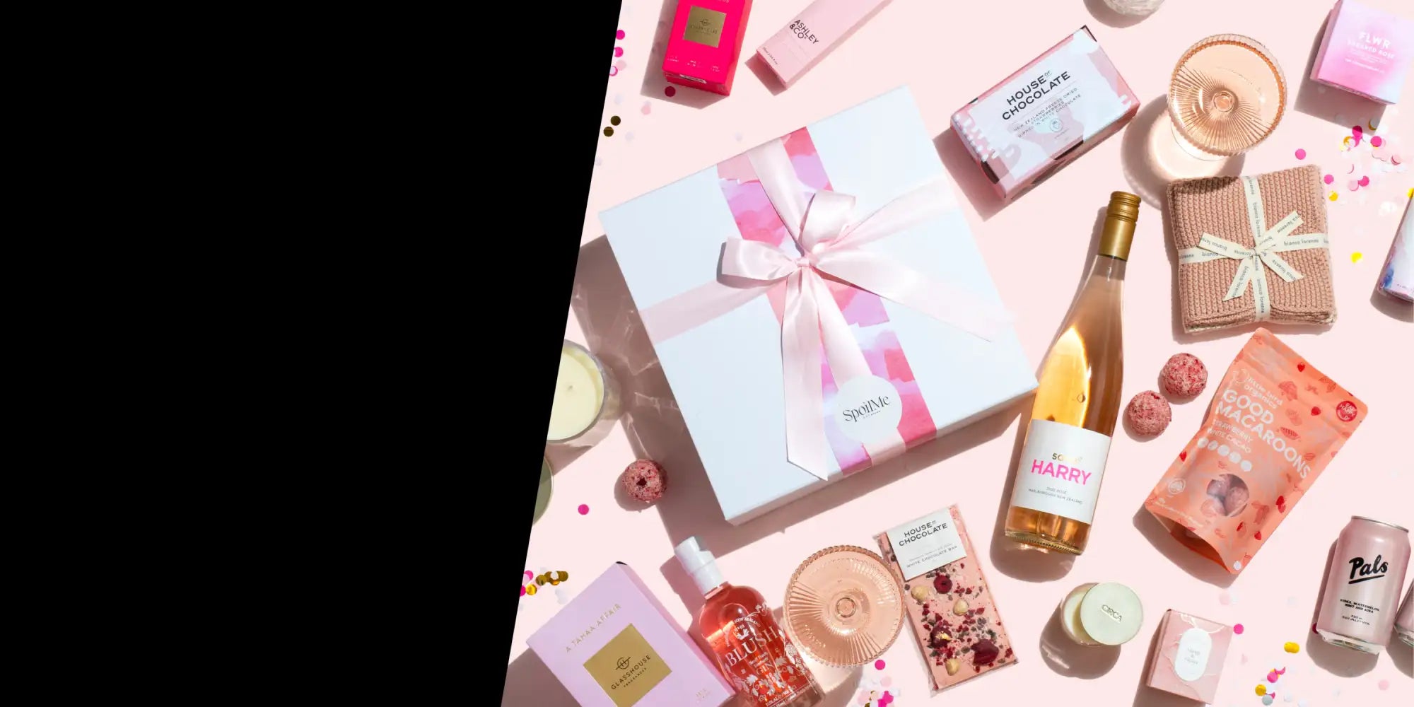 A white gift box with a pink ribbon bow and the brand name ’spark’ printed on its side.