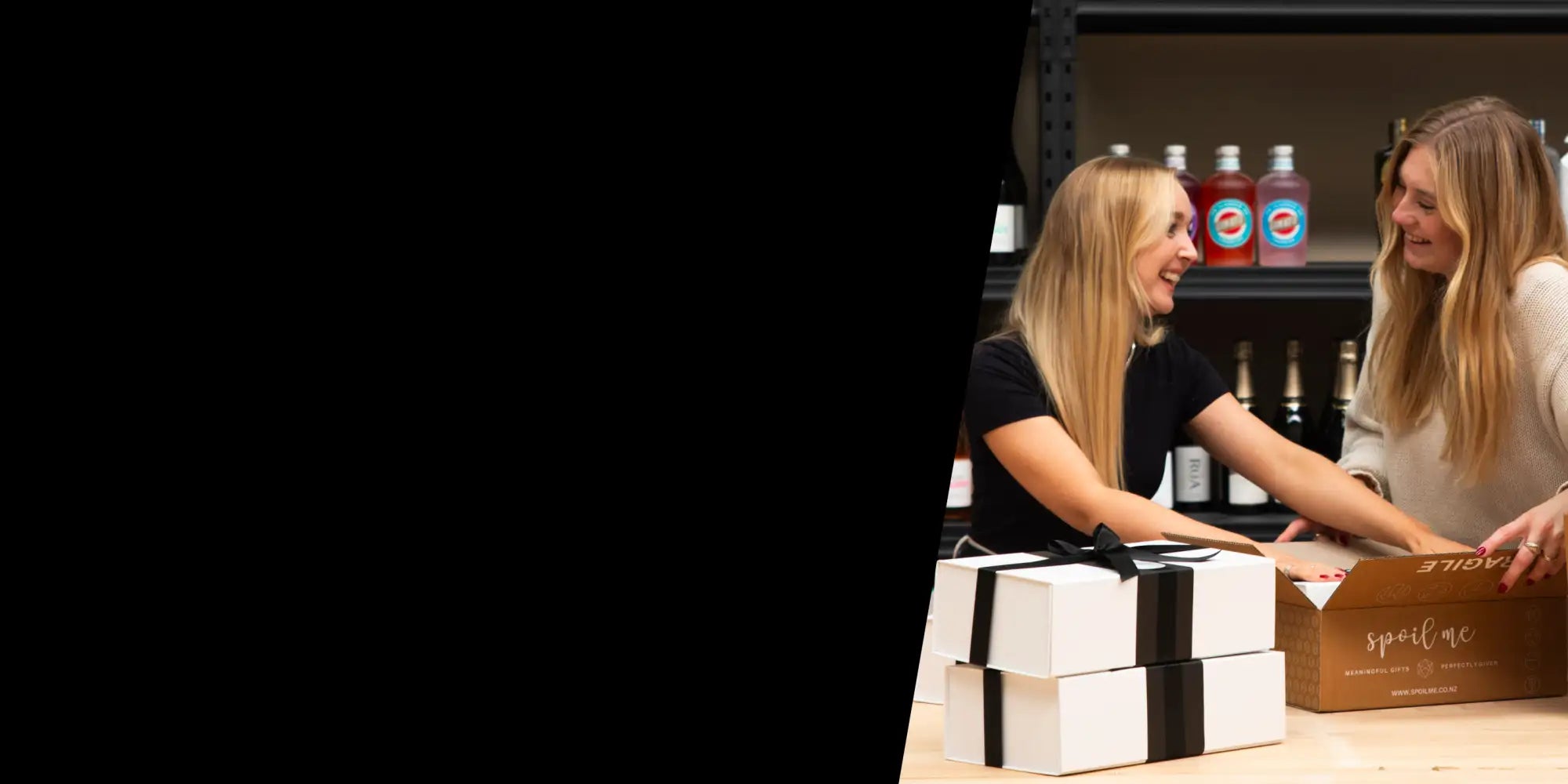White gift boxes with black ribbon ties